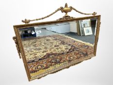 An ornate period style gilt overmantel mirror,