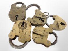 A group of antique brass padlocks.