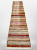 A contemporary machine made striped rug,