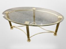 A brass and glass topped oval coffee table