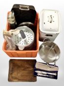 A vintage enameled bread bin, modern cooking pans,