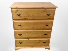 A contemporary pine four drawer chest,