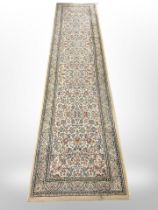 A machine made runner of Persian design,