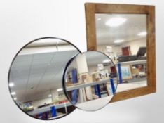 A contemporary wood-framed mirror and two circular mirrors.