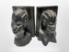 A pair of African carved wooden bookends, height 14cm.