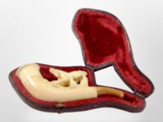 A vintage Meerschaum pipe in a fitted red velvet-lined case.