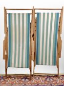 A pair of folding deck chairs