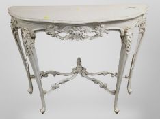 A French carved and cream painted serpentine front console table,