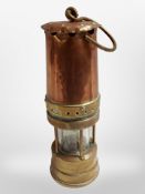 A copper and brass Protector miner's lamp.