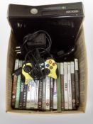 An Xbox 360 console with controllers and assorted games.
