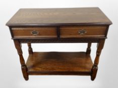 A reproduction oak side table, fitted drawers,