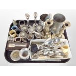 A group of silver-plated egg cups, pair of candlesticks, tankard, assorted cutlery, napkin rings.