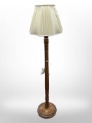 A contemporary turned wooden standard lamp,