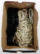 A box of faux and cultured pearls, mourning jewellery, jet, etc.