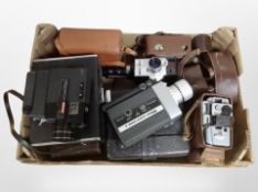 A collection of vintage cameras, handheld video cameras, including Sakyo, Nikon, Bell and Howel.