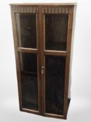 A reproduction oak glazed double door cabinet,