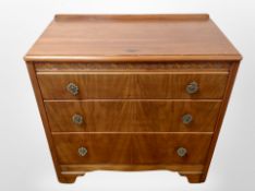 A 1930's walnut veneered three drawer chest,