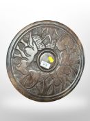 A Eastern carved hardwood circular plaque,