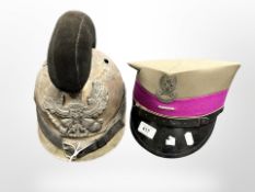 A WWI-style brass Picklehaube helmet, and a further reproduction military cap.