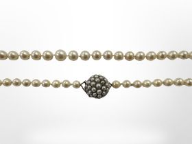 A good quality antique graduated pearl necklace with yellow gold pearl encrusted clasp,
