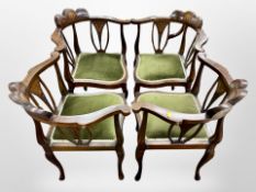 A set of four late Victorian mahogany and satin wood inlaid corner armchairs