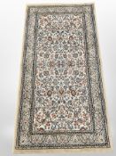 A machine made rug of Persian design,