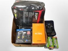 A box containing car seat covers, binoculars, BT phone, lightbulbs.