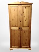 A contemporary pine double door wardrobe,