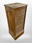 An Edwardian oak tambour front pedestal cabinet,