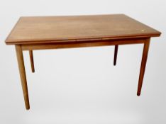 A 20th century teak pull-out extending dining table,