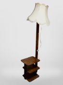 An Art Deco burr walnut veneered standard lamp book table