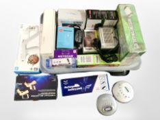 A box of assorted household electricals including headphones, Walkmans, digital set top box,