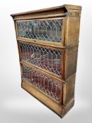 An Edwardian and oak leaded glass three tier stacking bookcase, in the style of Globe-Wernicke,