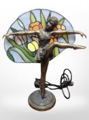 A contemporary Tiffany-style resin and glass table lamp modelled as a flapper girl, height 37cm.