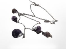 A Swarovski necklace with five graduated encrusted amethyst-coloured beads.