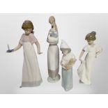 Three Nao figures of girls, and a similar Lladro figure, tallest 27cm.