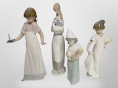 Three Nao figures of girls, and a similar Lladro figure, tallest 27cm.