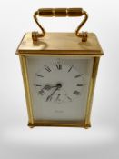 A brass-cased 8-day mantel timepiece signed Imhof, height 15cm including handle.