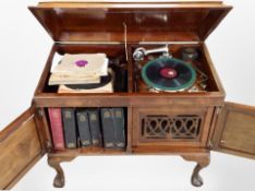 A reproduction mahogany record cabinet on claw and ball feet,