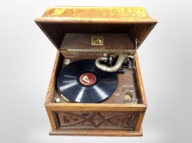 A His Master's Voice oak-cased gramophone.