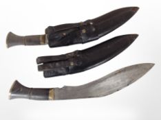 Two kukri knives in sheathes.