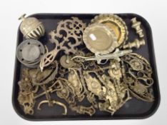 A collection of brass and pewter wares including dishes, drawer pull handles and doorknobs,