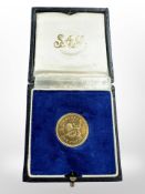A 1966 Rhodesia 22ct gold one pound coin, 7.98g, in navy blue box.