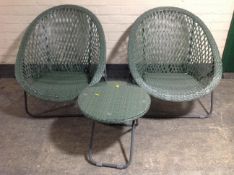 A pair of plastic garden lattice work chairs and a matching folding table