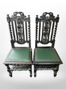 A pair of 19th century carved oak ebonised hall chairs