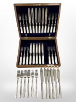 An oak canteen of EPNS and mother of pearl cake knives and forks with silver ferrules (lacking one