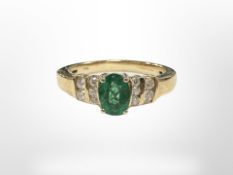 An 18ct gold emerald and diamond ring, size Q. CONDITION REPORT: 5.