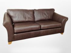 A contemporary brown stitched leather four piece lounge suite : four seater settee, length 224 cm,
