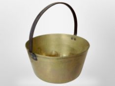 A Victorian brass jam pan with cast iron swing handle.