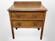 An Edwardian oak two drawer chest,